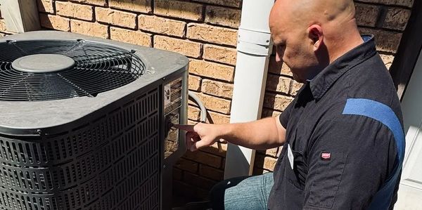 Corey Lambrecht, Oklahoma home inspector inspecting a condenser