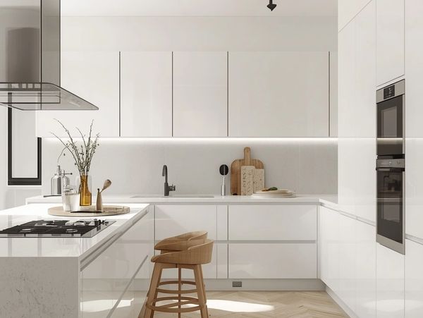 Bright modern kitchen with white cabinets and wooden stool.