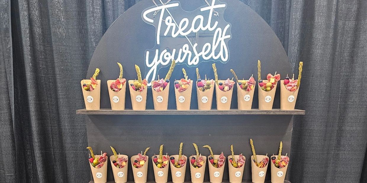 Rows of snack cones with a 'Treat yourself' sign.