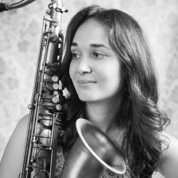 Woman posing with a saxophone.