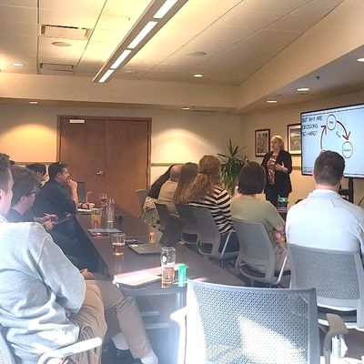Group of people attending a presentation in a conference room.