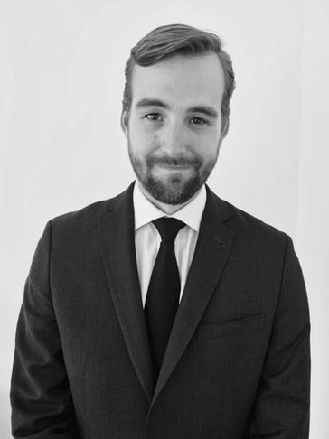 Professional portrait of a man in a suit and tie.