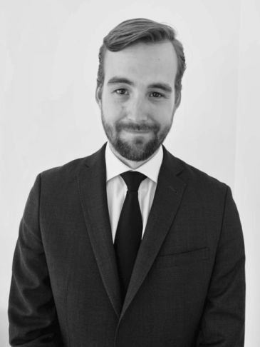 Professional portrait of a man in a suit and tie.