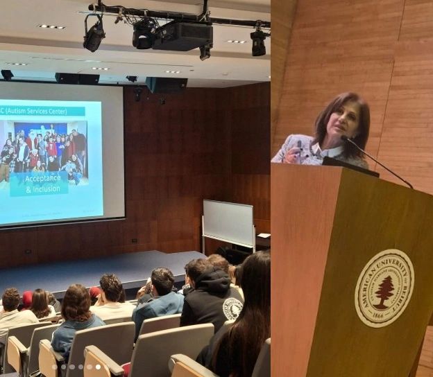 A woman giving a presentation about autism acceptance at a university lecture.
