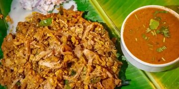 Traditional Indian meal served on a banana leaf with chutney and curry.