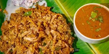 Traditional Indian meal served on a banana leaf with chutney and curry.