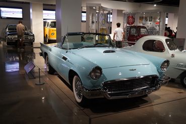 Light blue classic Ford Thunderbird convertible in a car museum.