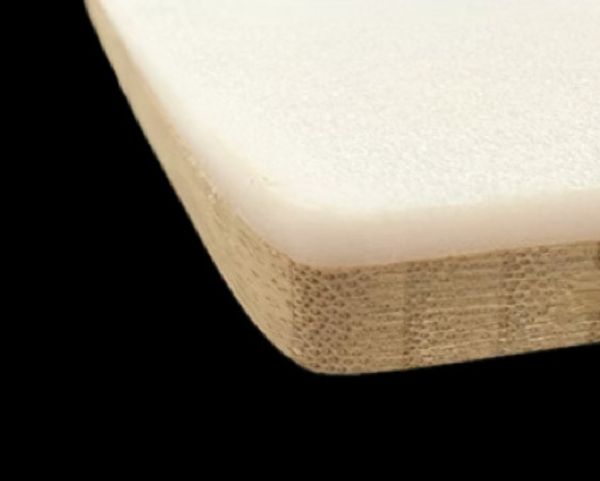 Close-up of a layered wooden board with a white top surface.