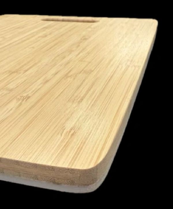 Smooth wooden cutting board with rounded edges and handle slot.