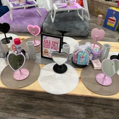 Sleepover setup with heart-shaped mirrors and skincare essentials.