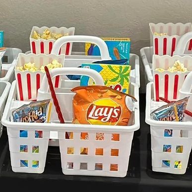 Snack baskets with popcorn, chips, and drinks.