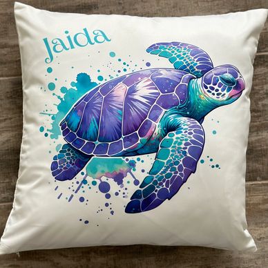 Decorative pillow with a vibrant sea turtle design and the name Jaida.