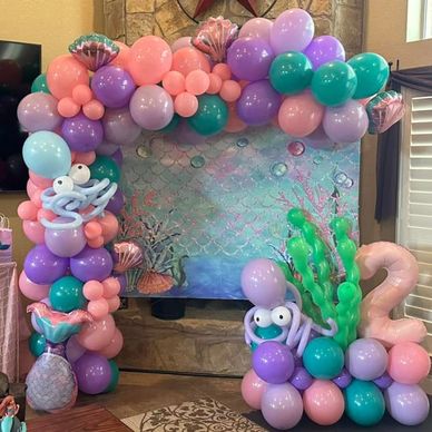 Colorful balloon arch with sea-themed decorations and marine creatures.