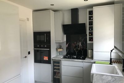 Modern kitchen with sleek appliances and marble countertops.