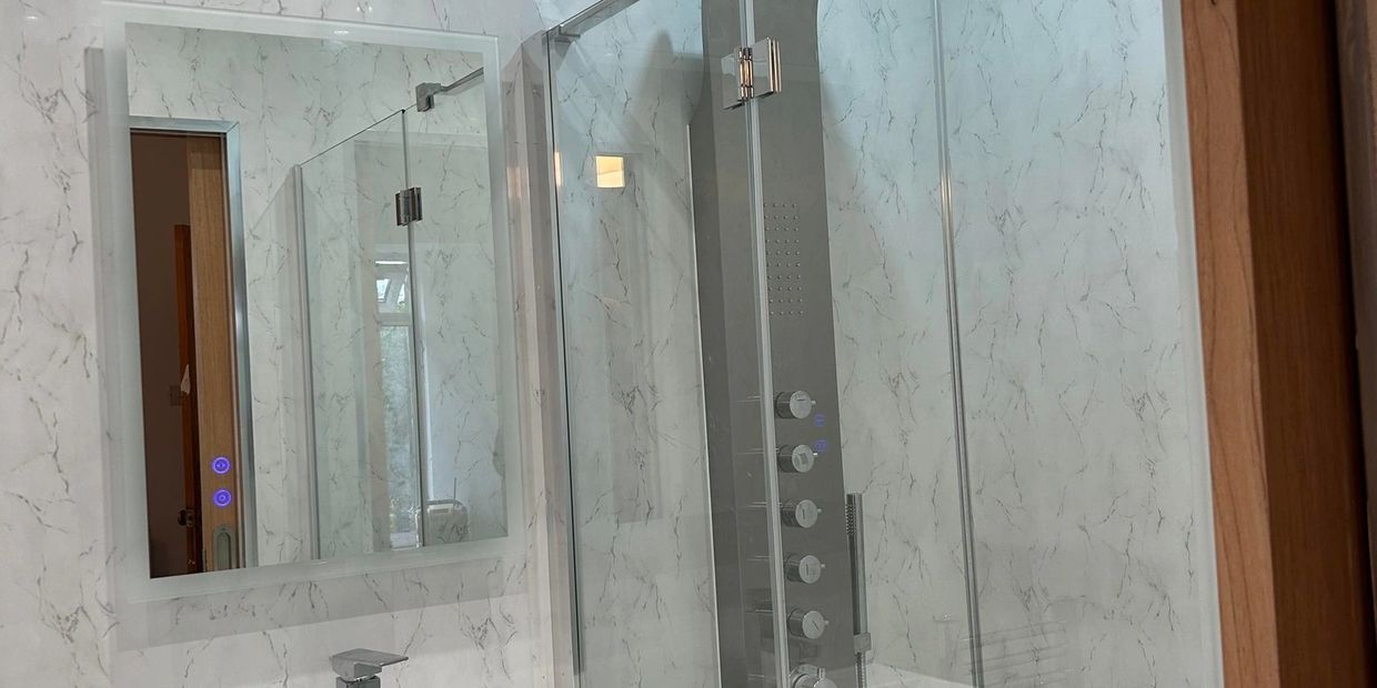 Modern bathroom with glass shower and sleek sink.