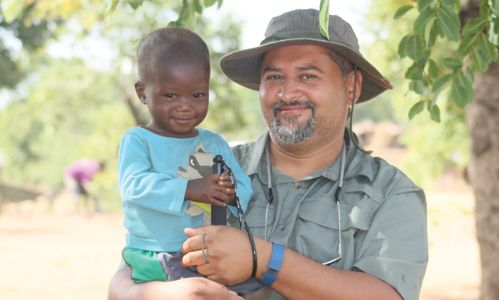 Dr Imran Khan holding Joshua, Malawi