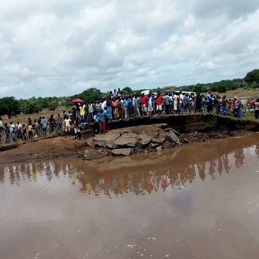 bridge washed away, people waiting on other side, stormy clouds