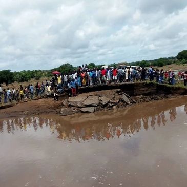 bridge washed away, people waiting on other side, stormy clouds