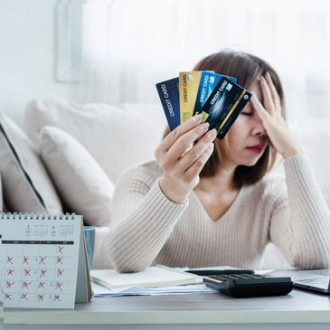 Borrower upset and overwhelmed by their personal credit card debt.
