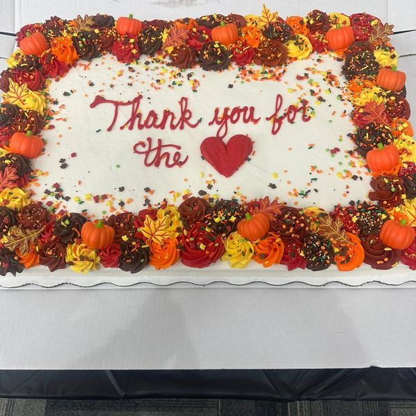 A festive cake with autumn-themed decorations and a thank you message.