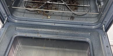 Close-up of dirty oven door and interior.