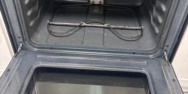 Clean, empty oven with open door.