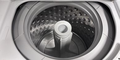 Empty top-loading washing machine drum.