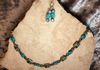 Ceramic peacock stones with glass beads. Length 25 in. Item #19-1-26. Price $20.00