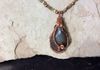 Close up of bloodstone with copper wire wrap