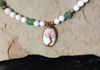 White and green glass beads, copper spacers, howlite pendant with Tree of Life copper wire wrapped. Length 26 in. Item # 19-1-1. Price $45.00