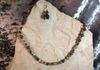 Green stone beads and antique colored spacers with earring. Length 28 in. Item #18-9-6. Price $20.00
