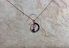 Circle loop pendant with wire wrap and swarovski crystals on opera length chain. 2 cm. Item #19-2-5. Price $10.00