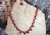 red glass faceted beads with clear spacers and spiral wrap beads. Includes earrings. Length 27 in. Item #19-1-20. Price $20.00