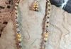 golden pearl beads with crystal spacers. Comes with earrings. Length 21 in. Item # 19-1-14a. Price $20.00
