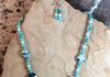 Blue and white glass beads with large swirl blue and white beads. Includes earrings. Length 22 in. Item # 19-1-18.  Price $20.00
