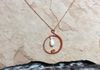 Circle loop pendant with wire wrap on opera length chain with Swarovski crystal and freshwater pearl. 1.5 inches. Item #19-2-6. Price $10.00