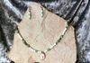 White and green glass beads, copper spacers, howlite pendant with Tree of Life copper wire wrapped. Length 26 in. Item # 19-1-1. Price $45.00