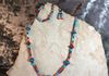 Black and blue and orange beads with wood and hematite spacers. Bracelet and earring set. Length 25 in. Item #18=10-15. Price $25.00