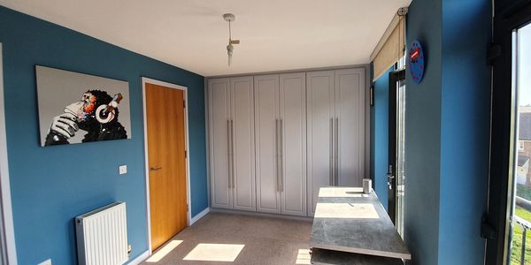 a boys bedroom painted blue and grey