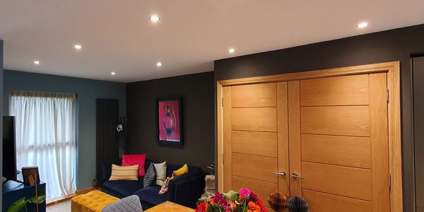 a vibrant colourful living room  with blues, blacks, whites and oak