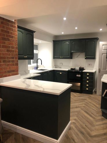 Oak kitchen that has been sprayed in farrow and ball studio green. 