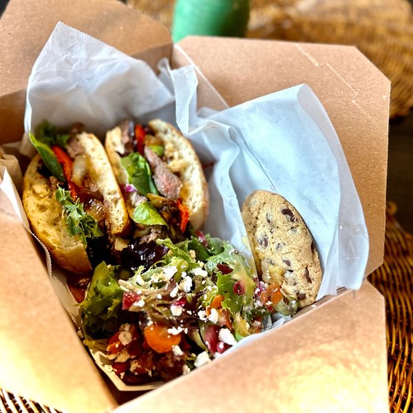 Boxed-lunch-Trip-tip-sandwich-on-focaccia-with roasted-red pepper-caramelized-onions-and-provolone. 