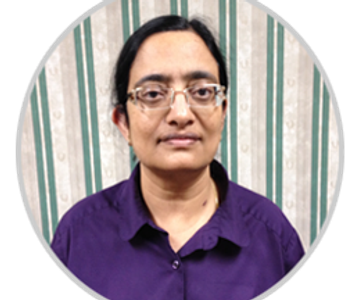 Portrait of a woman wearing glasses and a purple shirt.