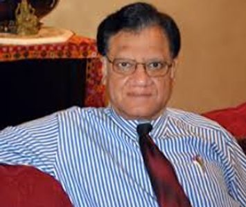 Man in glasses and striped shirt with red tie.