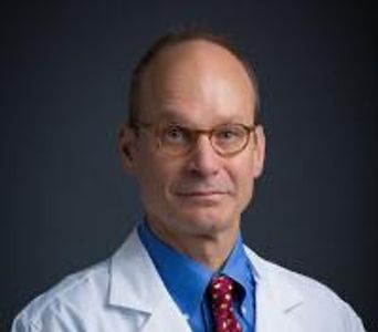 Professional male doctor with glasses and lab coat.
