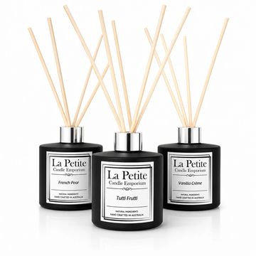 Three black reed diffusers with different scents.
