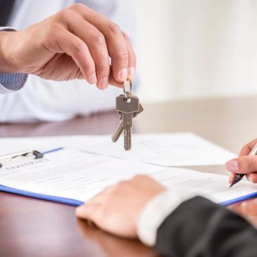 Handing over keys while signing a contract.