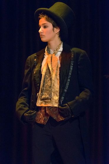Person in vintage formal attire and top hat.