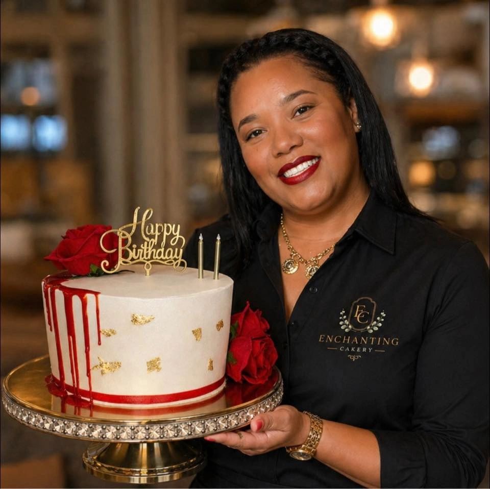 Woman smiling, holding a decorated birthday cake with red roses.