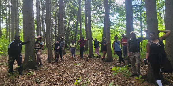 Group of people posing in a forest.